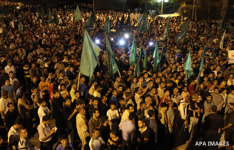 Palestinian members of Hamas celebrate a deal that will see Palestinian detainees freed in exchange for captured Israeli soldier Gilad Shalit on October 11, 2011, in Gaza City. Shalit was captured in 2006 by Hamas-allied...