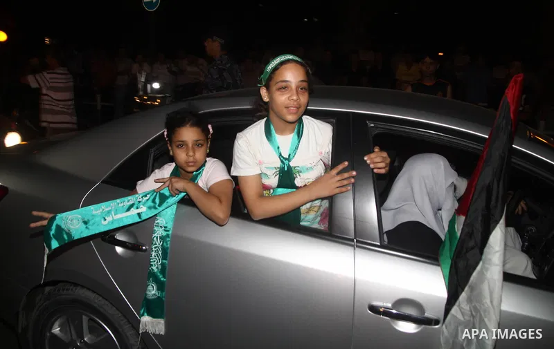 Palestinian members of Hamas celebrate a deal that will see Palestinian detainees freed in exchange for captured Israeli soldier Gilad Shalit on October 11, 2011, in Gaza City. Shalit was captured in 2006 by Hamas-allied...
