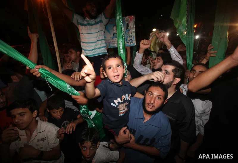 Palestinian members of Hamas celebrate a deal that will see Palestinian detainees freed in exchange for captured Israeli soldier Gilad Shalit on October 11, 2011, in Gaza City. Shalit was captured in 2006 by Hamas-allied...