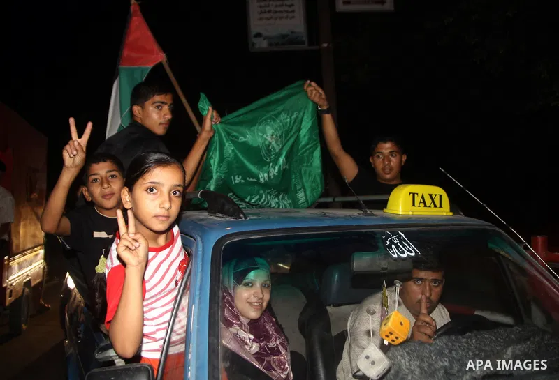 Palestinian members of Hamas celebrate a deal that will see Palestinian detainees freed in exchange for captured Israeli soldier Gilad Shalit on October 11, 2011, in Gaza City. Shalit was captured in 2006 by Hamas-allied...