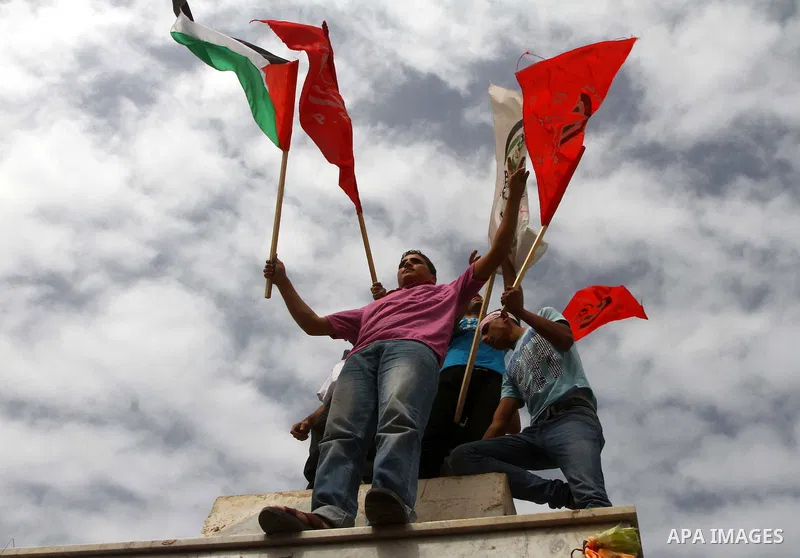 Palestinians celebrate a deal that will see Palestinian detainees freed in exchange for captured Israeli soldier Gilad Shalit on October 12, 2011 in Gaza City. Israel and Hamas have reached a deal that would see the rele...