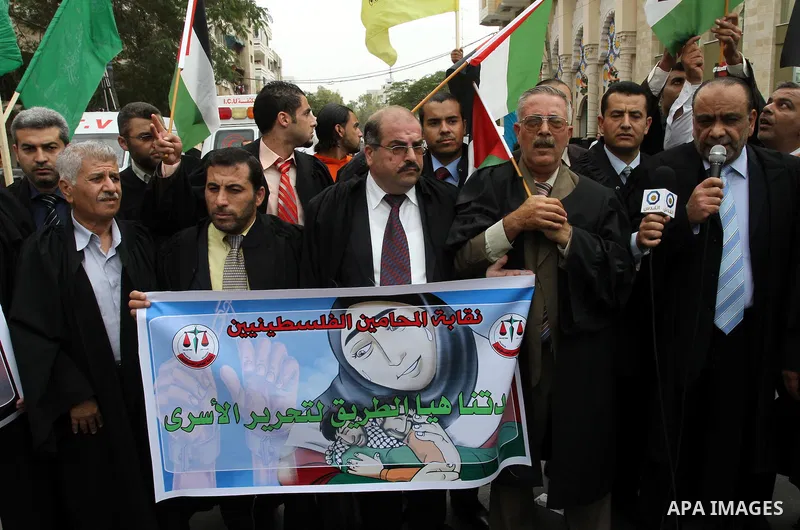 Palestinian lawyers demonstrate in solidarity with prisoners jailed in Israel in front of the International Red Cross building in Gaza City, Wednesday, Oct. 12, 2011. Israelis welcomed on Wednesday a major prisoner swap...