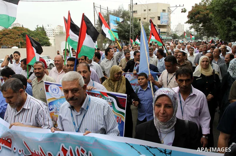 Palestinian UNRWA employees demonstrate in solidarity with prisoners jailed in Israel in front of the International Red Cross building in Gaza City, Wednesday, Oct. 12, 2011. Israelis welcomed on Wednesday a major prison...