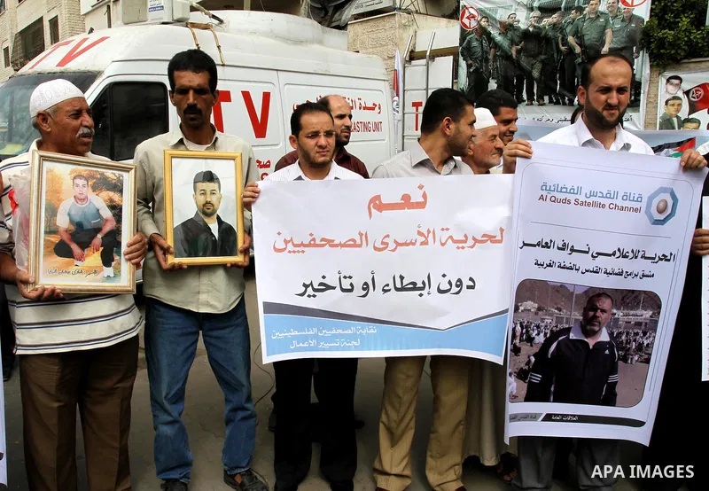 Palestinian journalists demonstrate in solidarity with prisoners jailed in Israel in front of the International Red Cross building in Gaza City, Wednesday, Oct. 12, 2011. Israelis welcomed on Wednesday a major prisoner s...