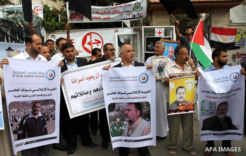 Palestinian journalists demonstrate in solidarity with prisoners jailed in Israel in front of the International Red Cross building in Gaza City, Wednesday, Oct. 12, 2011. Israelis welcomed on Wednesday a major prisoner s...