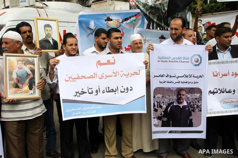 Palestinian journalists demonstrate in solidarity with prisoners jailed in Israel in front of the International Red Cross building in Gaza City, Wednesday, Oct. 12, 2011. Israelis welcomed on Wednesday a major prisoner s...