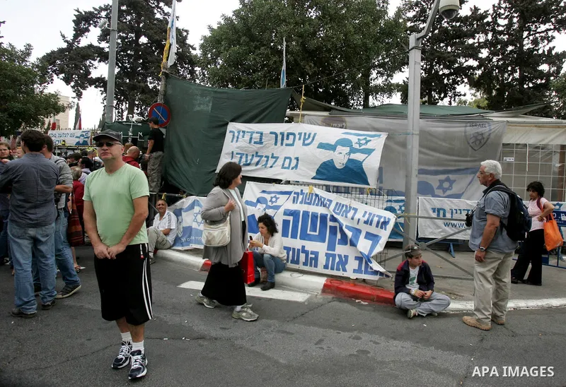 Friends and supporters of Noam and Aviva Shalit, parents of abducted Israeli soldier Gilad Shalit who was captured in 2006 by Hamas-allied militants in the Gaza Strip, gather at the family's protest tent on the 1,935th d...