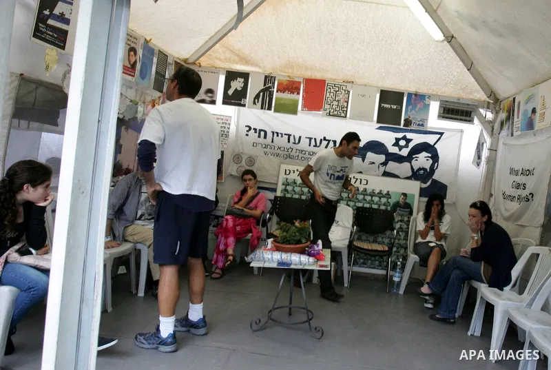 Friends and supporters of Noam and Aviva Shalit, parents of abducted Israeli soldier Gilad Shalit who was captured in 2006 by Hamas-allied militants in the Gaza Strip, gather at the family's protest tent on the 1,935th d...