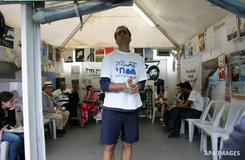 Friends and supporters of Noam and Aviva Shalit, parents of abducted Israeli soldier Gilad Shalit who was captured in 2006 by Hamas-allied militants in the Gaza Strip, gather at the family's protest tent on the 1,935th d...
