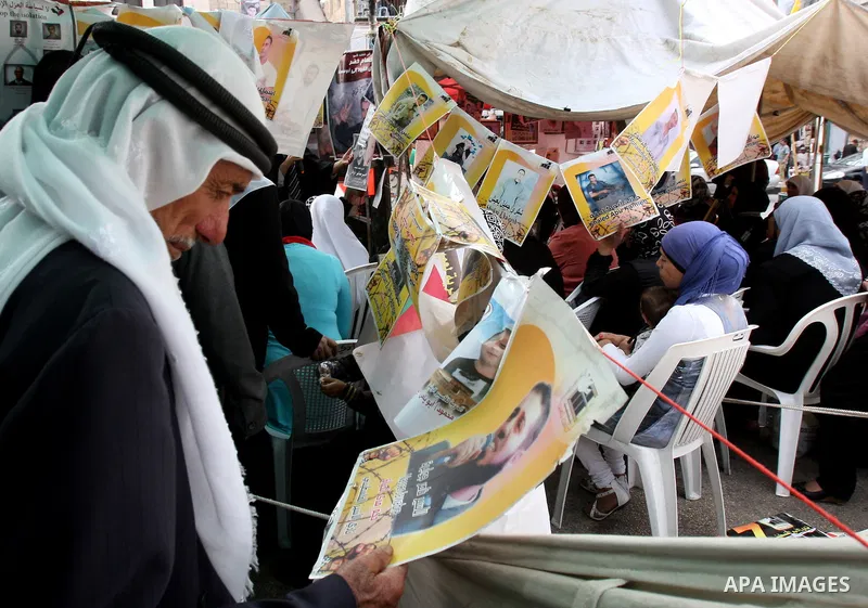Palestinians take part in a protest calling for the release of Palestinian prisoners from Israeli jails, in the West Bank city of Nablus, Wednesday, Oct. 12, 2011. Israelis welcomed on Wednesday a major prisoner swap tha...