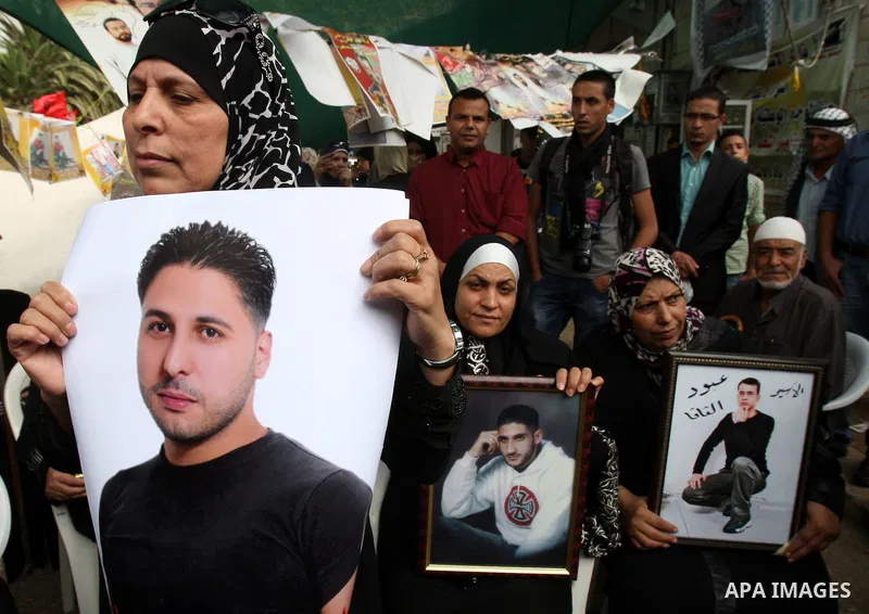 Palestinians take part in a protest calling for the release of Palestinian prisoners from Israeli jails, in the West Bank city of Nablus, Wednesday, Oct. 12, 2011. Israelis welcomed on Wednesday a major prisoner swap tha...
