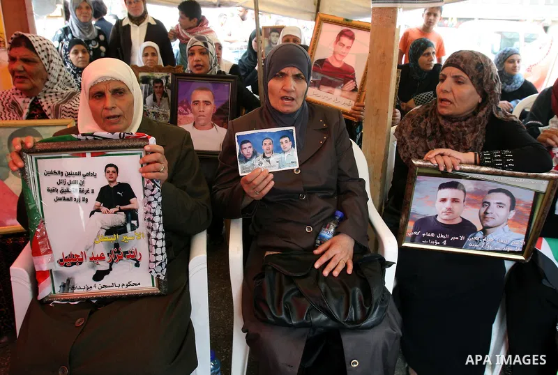 Palestinians take part in a protest calling for the release of Palestinian prisoners from Israeli jails, in the West Bank city of Nablus, Wednesday, Oct. 12, 2011. Israelis welcomed on Wednesday a major prisoner swap tha...