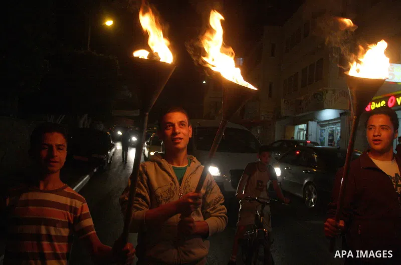 Families of prisoners being held in Israeli jails hold a candlelight vigil at the United Nations and Red Cross headquarters in the West Bank city of Ramallah, on October 12, 2011, to show support for prisoners on their t...