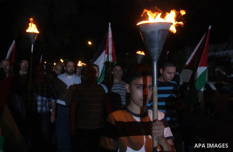 Families of prisoners being held in Israeli jails hold a candlelight vigil at the United Nations and Red Cross headquarters in the West Bank city of Ramallah, on October 12, 2011, to show support for prisoners on their t...