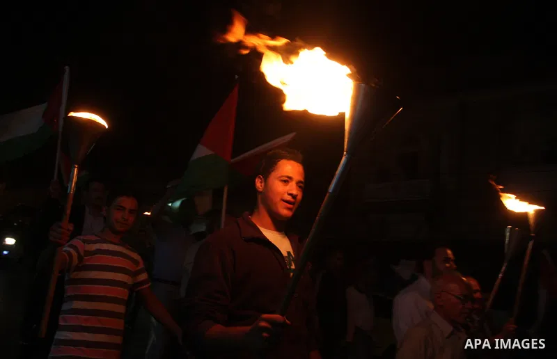 Families of prisoners being held in Israeli jails hold a candlelight vigil at the United Nations and Red Cross headquarters in the West Bank city of Ramallah, on October 12, 2011, to show support for prisoners on their t...