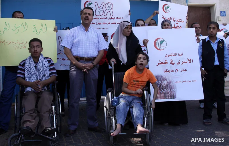 NGOs take part in a rally celebrating a prisoner swap between Hamas and Israel, in Gaza City Oct, 13, 2011. Israelis welcomed on Wednesday a major prisoner swap that will free soldier Gilad Shalit after five years in cap...