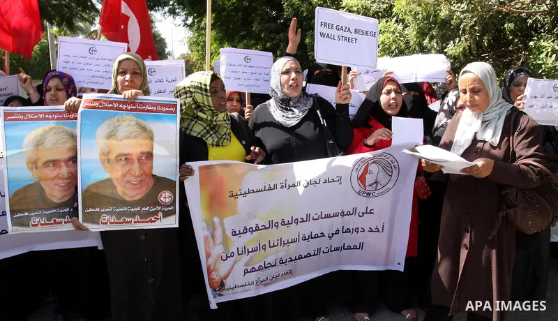Women's Committees Federation take part in a protest in solidarity with Palestinian prisoners held in Israeli jails in a protest tent in front of the Red Cross' offices in east Jerusalem, on Oct, 13, 2011. Thousands of P...