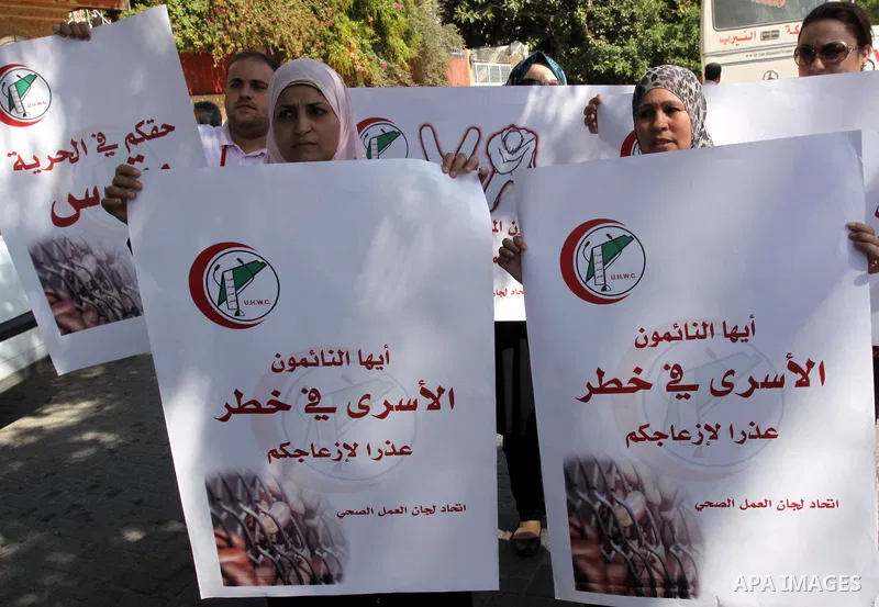 NGOs take part in a rally celebrating a prisoner swap between Hamas and Israel, in Gaza City Oct, 13, 2011. Israelis welcomed on Wednesday a major prisoner swap that will free soldier Gilad Shalit after five years in cap...