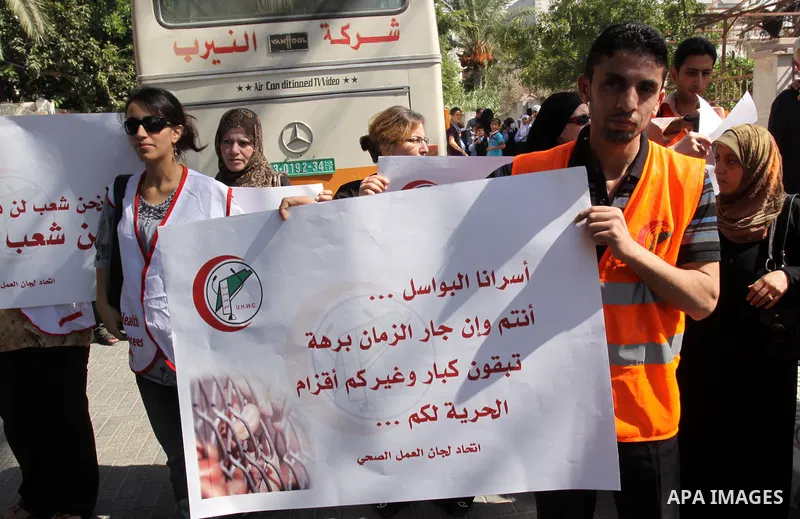 NGOs take part in a rally celebrating a prisoner swap between Hamas and Israel, in Gaza City Oct, 13, 2011. Israelis welcomed on Wednesday a major prisoner swap that will free soldier Gilad Shalit after five years in cap...