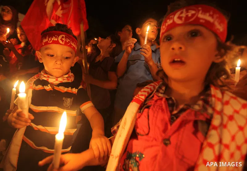 Palestinian children hold candles during a rally in solidarity with Palestinian prisoners held in Israeli jails, in Gaza City October 13, 2011. Israeli soldier Gilad Shalit will be freed from five years of captivity in t...
