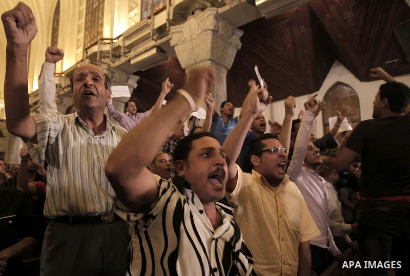 Nearly 3,000 Egyptian mourners gather in central Cairo on October 13, 2011 in honour of Coptic Christians among 25 people killed in weekend clashes during a demonstration over an attack on a church. Egypt's government sa...