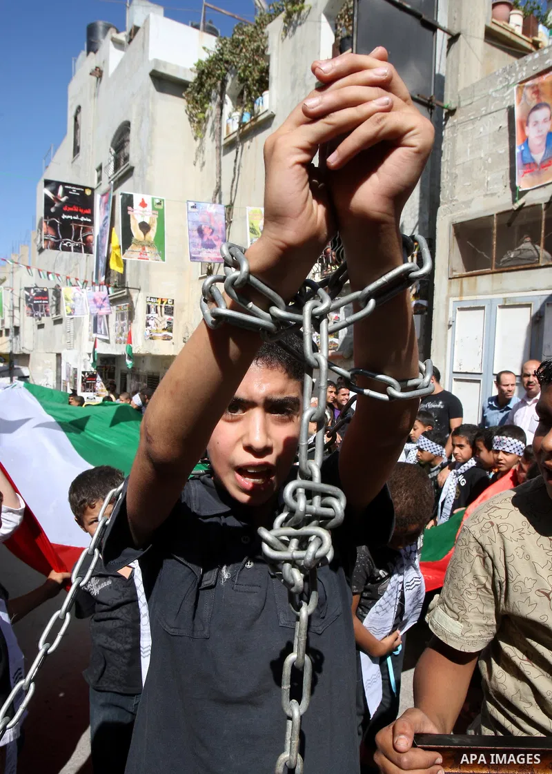 Palestinians take part in a rally supporting the prisoners in Israeli jails in the Askar refugee camp in the West Bank city of Nablus, Friday Oct. 14, 2011. The case of prisoners in Israeli jails is deeply sensitive for...