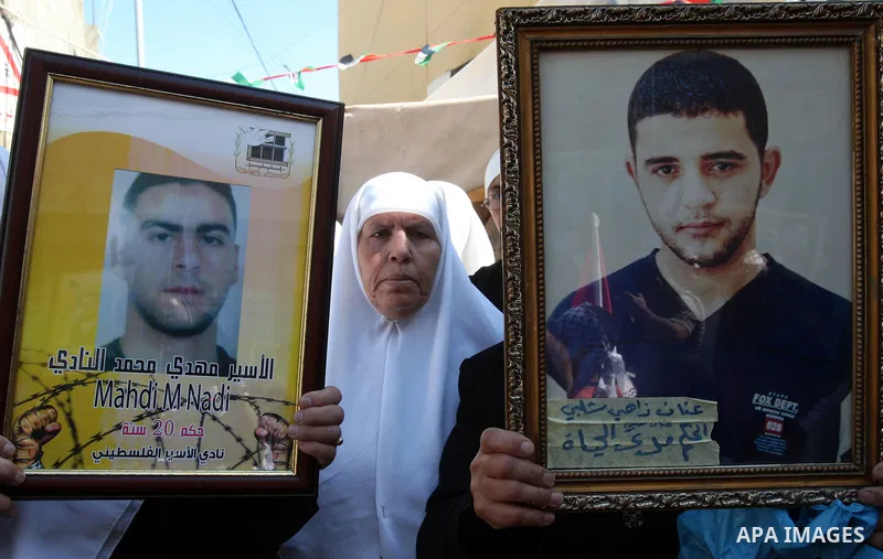 .Palestinians take part in a rally supporting the prisoners in Israeli jails in the Askar refugee camp in the West Bank city of Nablus, Friday Oct. 14, 2011. The case of prisoners in Israeli jails is deeply sensitive for...
