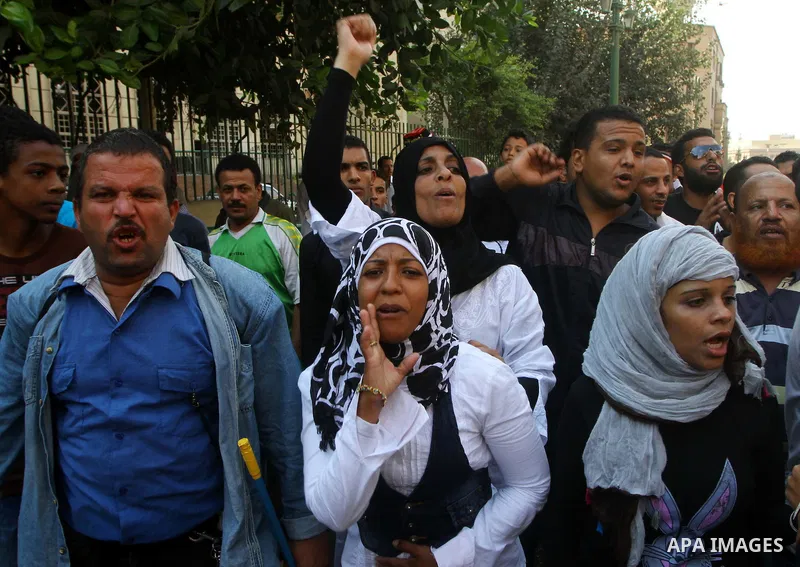 Egyptian protesters shout slogans during a demonstration outside a mosque in Cairo in support of national unity that led to a clash between pro- and anti-military supporters on October 14, 2011. The military has run Egyp...