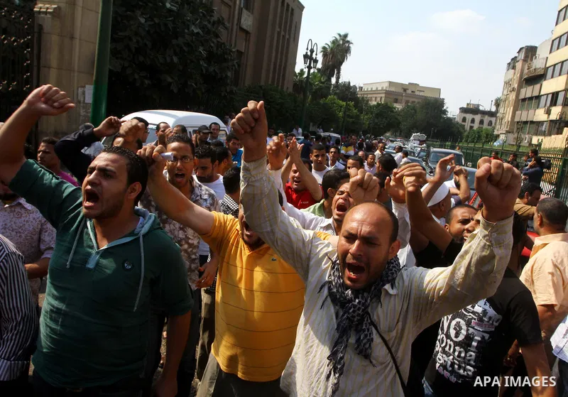 Egyptian protesters shout slogans during a demonstration outside a mosque in Cairo in support of national unity that led to a clash between pro- and anti-military supporters on October 14, 2011. The military has run Egyp...