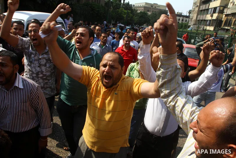 Egyptian protesters shout slogans during a demonstration outside a mosque in Cairo in support of national unity that led to a clash between pro- and anti-military supporters on October 14, 2011. The military has run Egyp...
