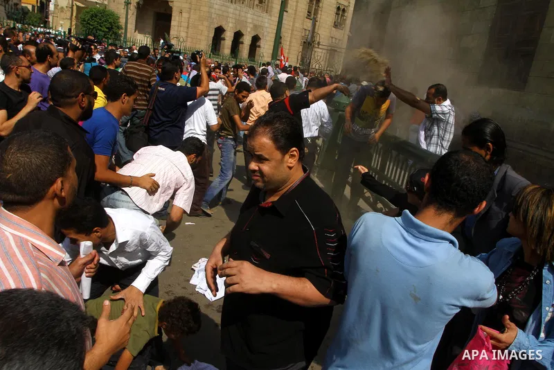 Egyptian pro- and anti-military supporters clash during a demonstration in support of national unity outside a mosque in Cairo on October 14, 2011. The military has run Egypt since president Hosni Mubarak was ousted in F...