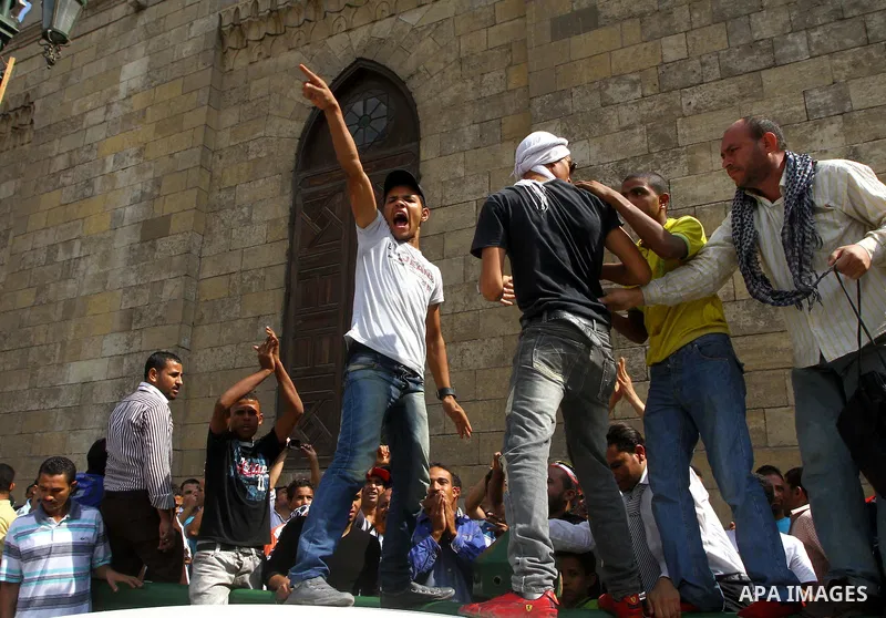 Egyptian protesters shout slogans during a demonstration outside a mosque in Cairo in support of national unity that led to a clash between pro- and anti-military supporters on October 14, 2011. The military has run Egyp...