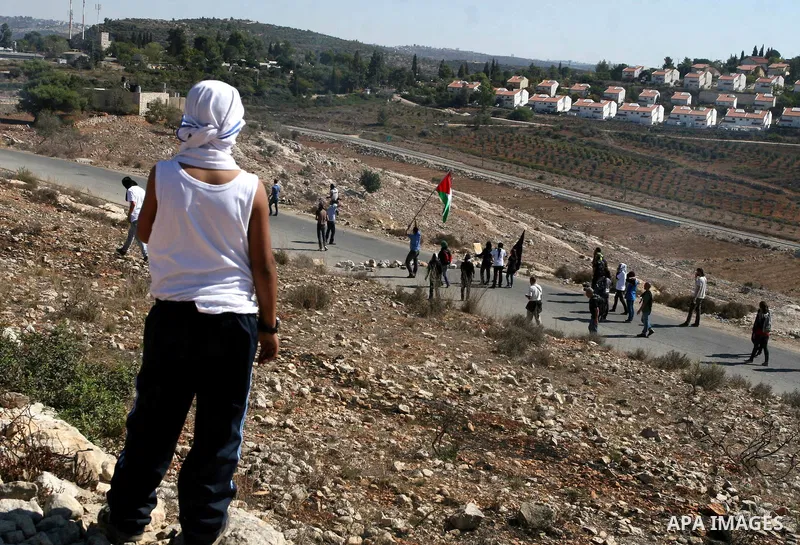 Palestinian protestors take part in a demonstration against the expansion of the nearby Jewish settlement of Halamish in the West Bank village of Nabi Saleh, near Ramallah, Friday, Oct. 14, 2011. Photo by Issam Rimawi