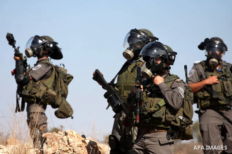 Israeli forces clash with Palestinian stone throwers during a demonstration against the expansion of the nearby Jewish settlement of Halamish in the West Bank village of Nabi Saleh, near Ramallah, Friday, Oct. 14, 2011....