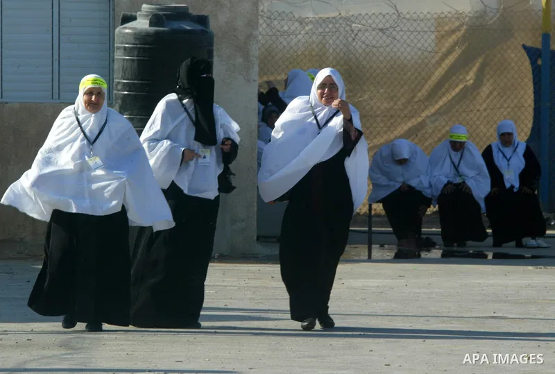 Palestinian pilgrims arrive at the Rafah border crossing between the Gaza Strip and Egypt on their way to the annual hajj or pilgrimage in the Saudi Muslim holy city of Mecca, on October 14, 2011. Photo by Abed Rahim Kha...