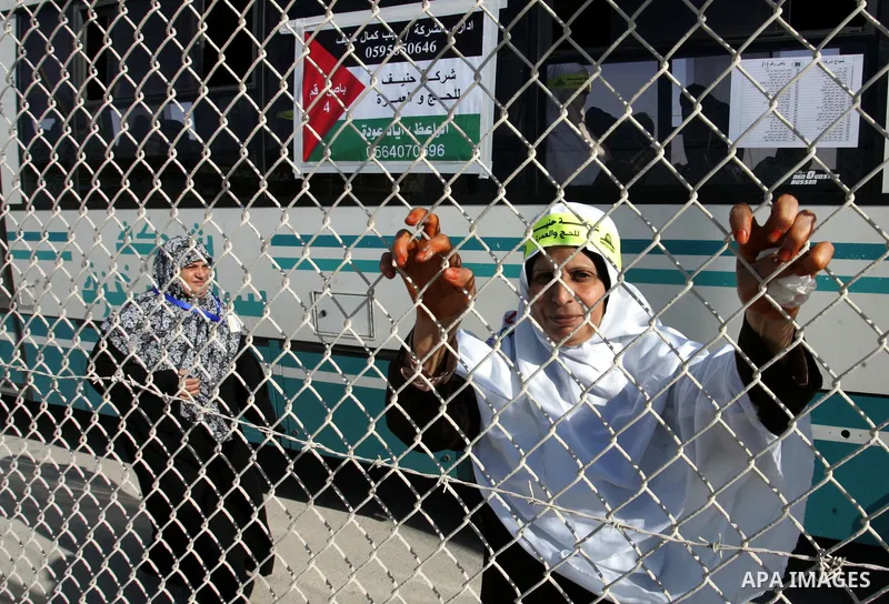 Palestinian pilgrims arrive at the Rafah border crossing between the Gaza Strip and Egypt on their way to the annual hajj or pilgrimage in the Saudi Muslim holy city of Mecca, on October 14, 2011. Photo by Abed Rahim Kha...