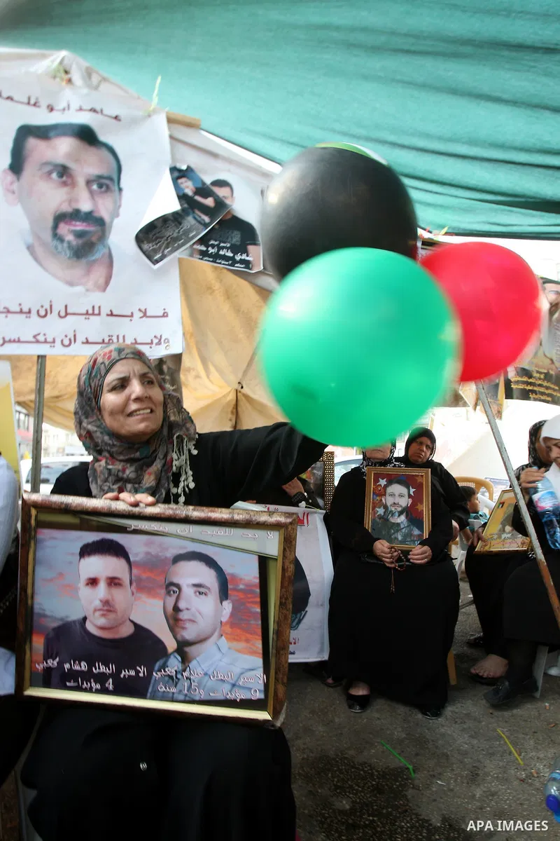 Palestinians celebrate the prisoner exchange deal between Hamas and Israel, in the West Bank city of Nablus Saturday, Oct.15, 2011. It is expected that Hamas will free the captured Israeli soldier Gilad Schalit in exchan...