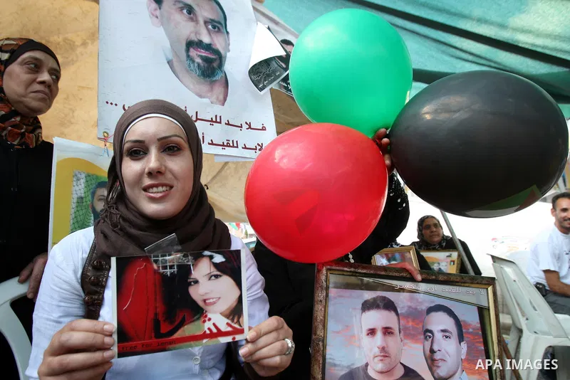 Palestinians celebrate the prisoner exchange deal between Hamas and Israel, in the West Bank city of Nablus Saturday, Oct.15, 2011. It is expected that Hamas will free the captured Israeli soldier Gilad Schalit in exchan...