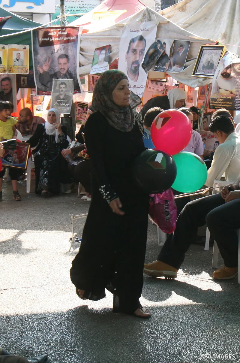 Palestinians celebrate the prisoner exchange deal between Hamas and Israel, in the West Bank city of Nablus Saturday, Oct.15, 2011. It is expected that Hamas will free the captured Israeli soldier Gilad Schalit in exchan...