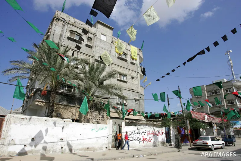 The families of Palestinian prisoners loyal to the leader of the Palestinian Fatah party led by Mahmoud Abbas, Hamas flags decorate their homes in Rafah town in the southern Gaza Strip on October 16, 2011. Israel on Sund...