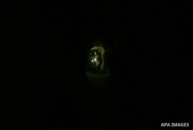 Palestinian men smuggle gravels into the Gaza Strip through a tunnel under the Egypt-Gaza border in Rafah on Oct. 16, 2011. Israel released a list of 477 Palestinian prisoners to be released next week as part of the deal...