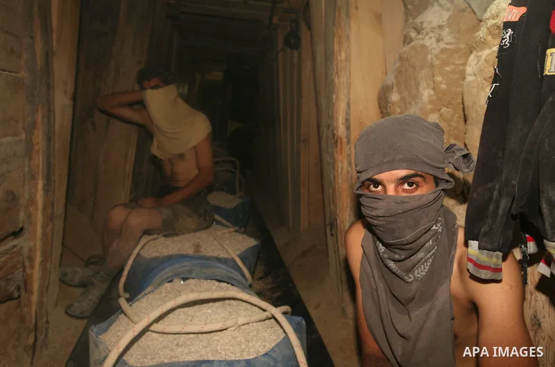 Palestinian men smuggle gravels into the Gaza Strip through a tunnel under the Egypt-Gaza border in Rafah on Oct. 16, 2011. Israel released a list of 477 Palestinian prisoners to be released next week as part of the deal...