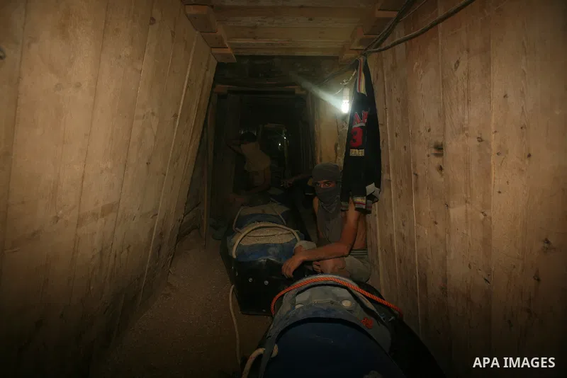 Palestinian men smuggle gravels into the Gaza Strip through a tunnel under the Egypt-Gaza border in Rafah on Oct. 16, 2011. Israel released a list of 477 Palestinian prisoners to be released next week as part of the deal...