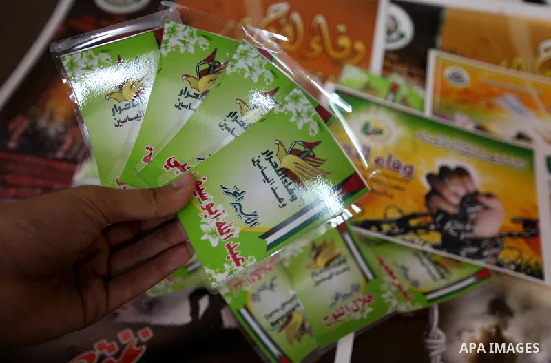 Palestinians print posters in preparation for a prisoner swap between Hamas and Israel in Gaza City, Sunday, Oct. 16, 2011. Relatives of Israelis killed in Palestinian attacks waged a charged debate Sunday over the plann...