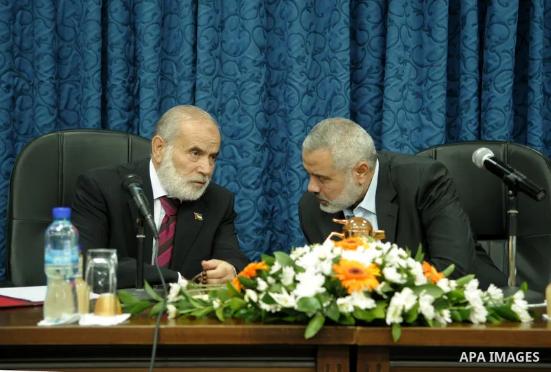 Palestinian Prime Minister in Gaza Strip, Ismail Haniyeh attends a meeting with his ministers and legislators in his office in Gaza City, Sunday, Oct. 16, 2011. The relatives of Israelis killed in Palestinian attacks wag...