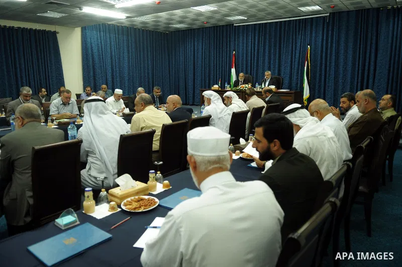 Palestinian Prime Minister in Gaza Strip, Ismail Haniyeh attends a meeting with his ministers and legislators in his office in Gaza City, Sunday, Oct. 16, 2011. The relatives of Israelis killed in Palestinian attacks wag...