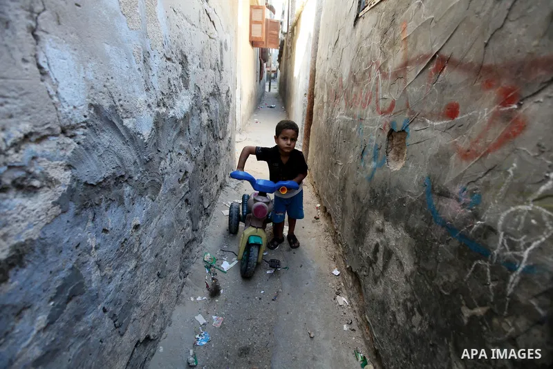 Palestinian children play at alley in Shati refugee camp in Gaza City, Sunday, Oct. 16, 2011. The relatives of Israelis killed in Palestinian attacks waged a charged debate Sunday over the planned release of militants th...