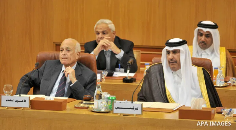Arab League secretary general Nabil al-Arabi (L) and Qatari Premier and Foreign Minister Sheikh Hamad bin Jassem al-Thani attend an emergency meeting of Arab foreign ministers at the Arab League headquarters in Cairo on...