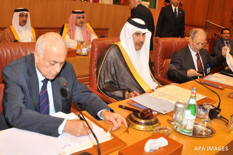 Arab League Secretary General Nabil Alarabi (L), Qatari Foreign Minister Hamad bin Jasim (C) and Arab League representative Ahmed Bin Hille (R) attend the Arab Foreign Ministers emergency meeting on Syria, at the Arab Le...