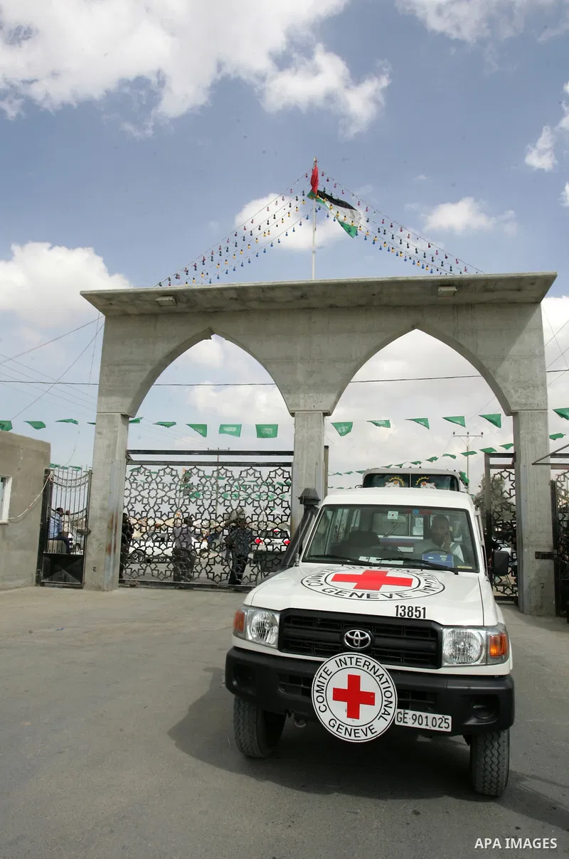 Red Cross vehicles and buses arrive from Egypt to the Rafah crossing in the southern Gaza Strip on Oct, 17. 2011 for the upcoming transfer of Palestinian prisoners from Israel to Gaza . Under a prisoner swap deal signed...